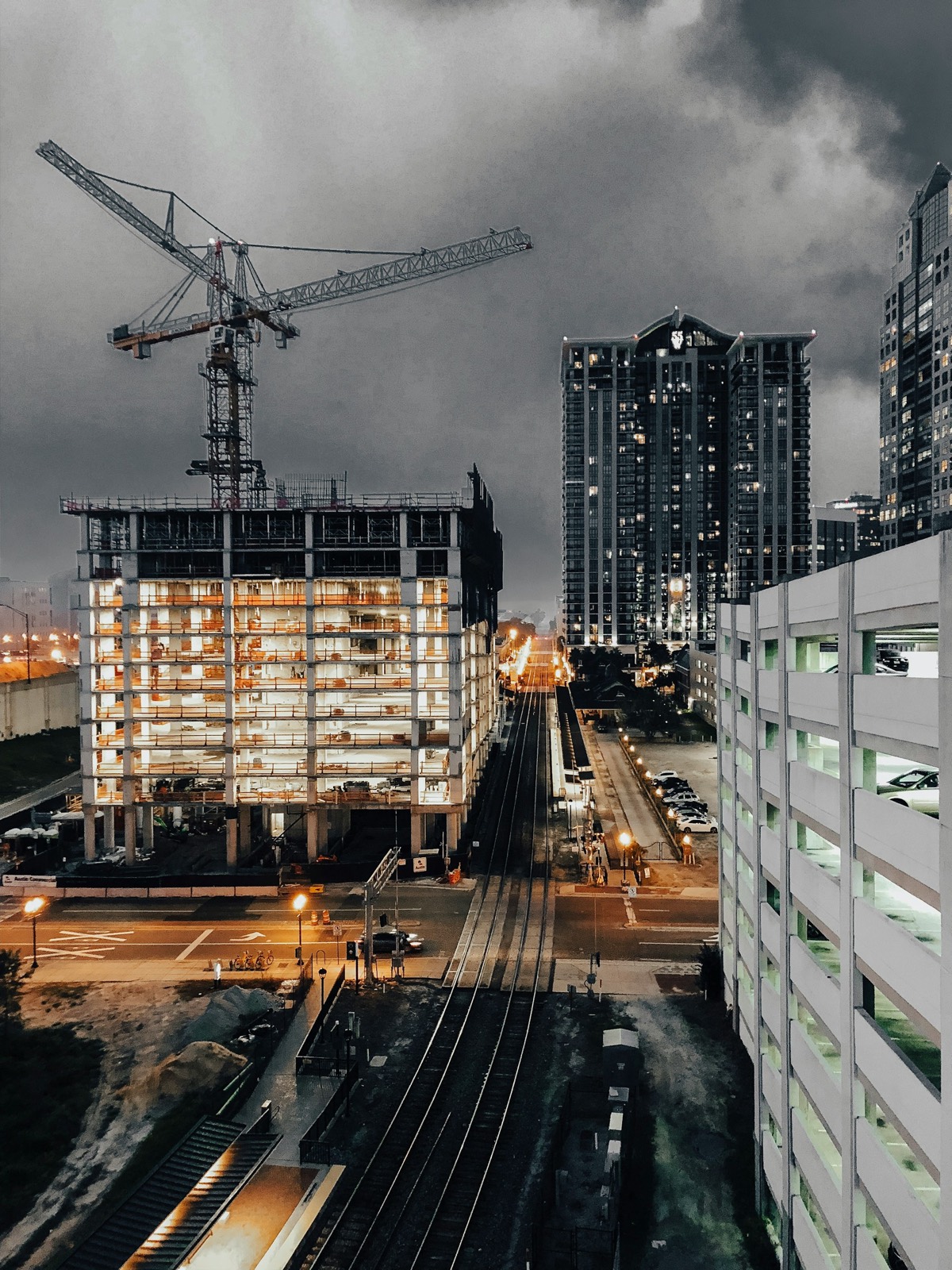 Tower crane over a construction site at dusk